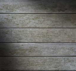 Grayish weathered horizontal wood lit diagonally