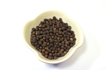 black pepper in a  bowl isolated on white background