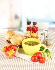 Fragrant soup in cup on table in kitchen