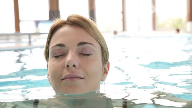 Woman relaxing in spa center pool