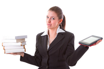 Woman having dilemma between stack of books and ebook reader