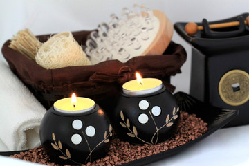 Spa composition with candles, aromatic oil and a massage brush