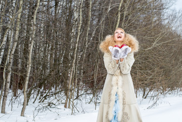 Sincerely laughing young woman in a winter forest