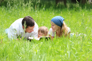 family with a young daughter reads the Bible