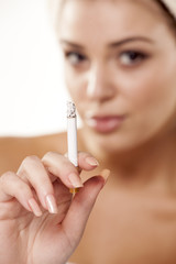 girl showing her cigarette with focus on foreground