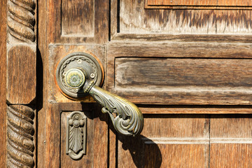 Texture of old wooden door with a metal handle