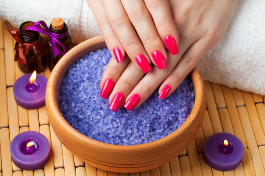 female hands with aromatic candles and towel. Spa