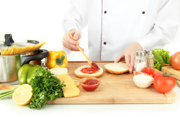 Female hands preparing cheeseburger, isolated on white