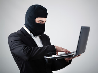 Hacker stealing information from laptop