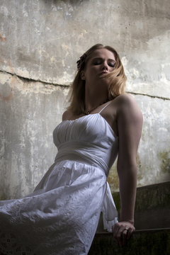Beautiful Young Blonde Woman with White Dress