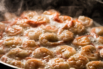 Fried shrimp in butter on a frying pan