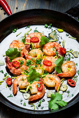 Closeup of shrimps on pan with fresh herbs