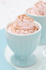 dessert of whipped cream topped with grated chocolate closeup