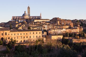 Fototapeta premium Old town of medieval Siena at sunset.