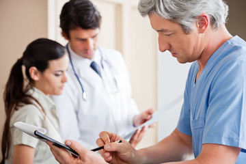 Doctor Writing On Clipboard