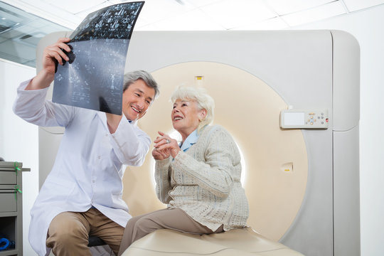 Radiologist With Patient Looking At CT Scan Results