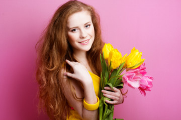 Beautiful redheaded girl with tulips