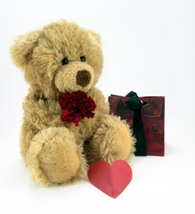Cuddly ted with red flower and heart.