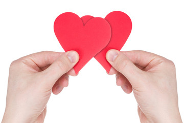 Obraz premium Hands holding two red paper hearts