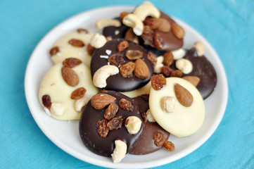 Black, white and milk chocolate with nuts and raisins