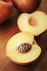 Peach cut in half with focus on peach pit.