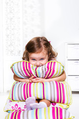 Toddler girl with pillows