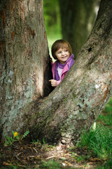 little girl climbing tree in the park