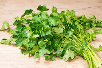 Fresh parsley leaves on wooden table