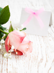Blank card for your message and pink rose