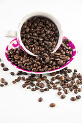 Cup full of coffee beans on light background