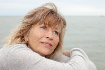 close up portrait of mature woman daydreaming outdoors
