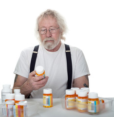 Senior looking at a bottle of pills