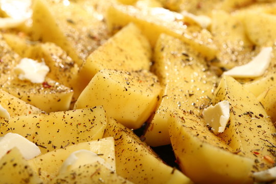 Raw potatoes with spices ready to be roasted