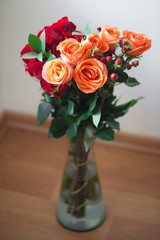 bouquet of colorful roses in a vase on white background
