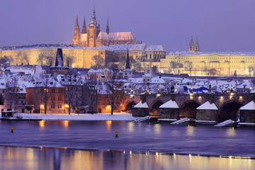 Night colorful snowy Prague gothic Castle with Charles Bridge