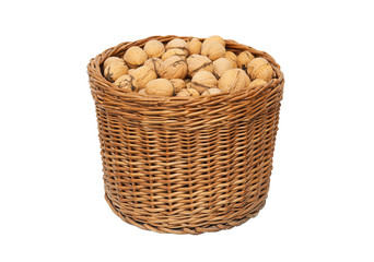Walnuts in wicker basket isolated on white background