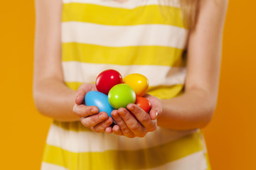Fototapeta na wymiar Close-up of multi colored easter egg in hands
