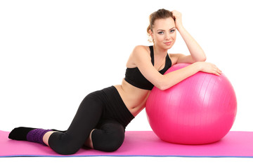 Young woman with gym ball isolated on white