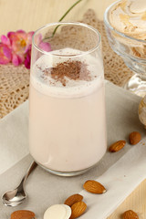 Glass of chocolate-cream cocktail on wooden table close-up