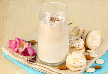 Glass of chocolate-cream cocktail on wooden table close-up