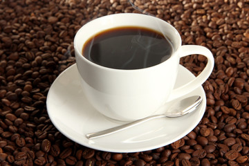 Cup of coffee on coffee beans background