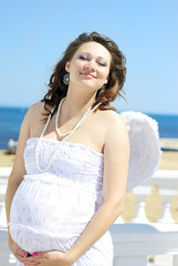 Fototapeta na wymiar beautiful pregnant with a girl with wings