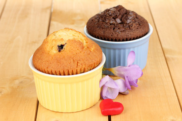 Cupcakes in bowls for baking on wooden table