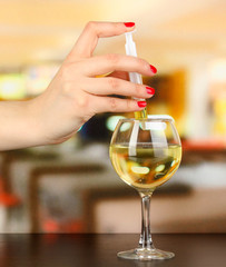 Pour something into glass with drink