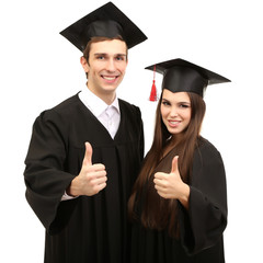 Two happy graduating students  isolated on white