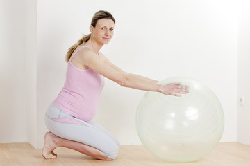 pregnant woman doing exercises with a ball