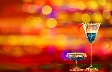 Two blue curacao cocktails and city illumination