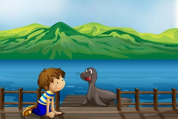 Tuinposter Een jongen en een zeeleeuw © GraphicsRF