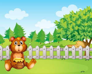 A bear holding a honey at the backyard