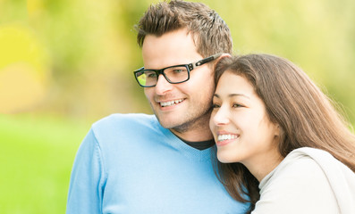 Obraz premium Portrait of happy young man and woman in park.